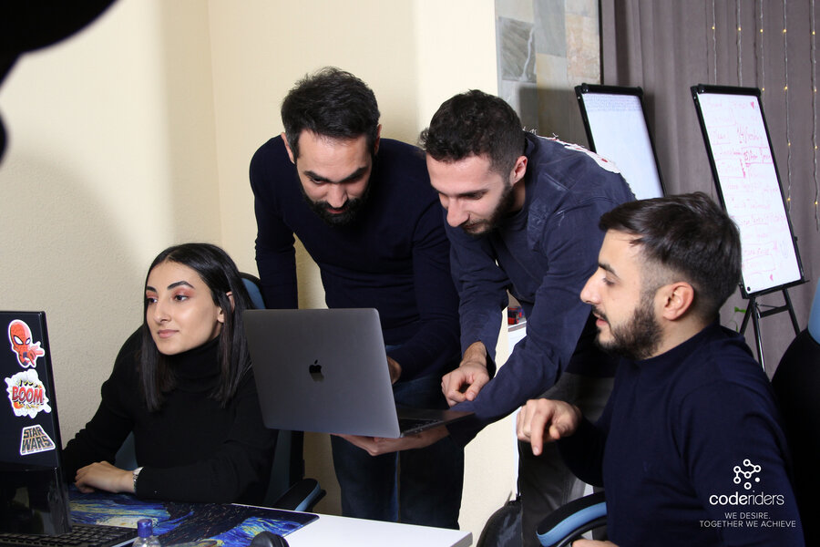 CodeRiders software developers and designers including senior software engineer Shant working on a complex software development project